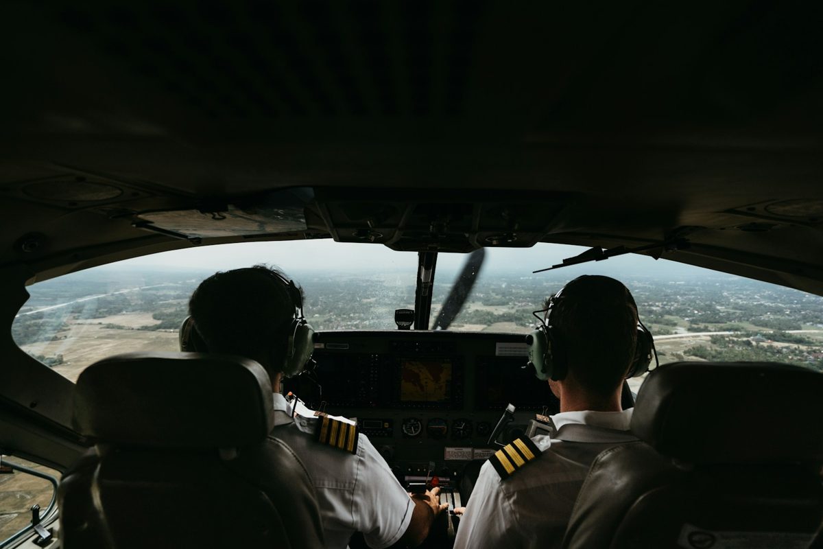 Two pilots flying together in the cockpit